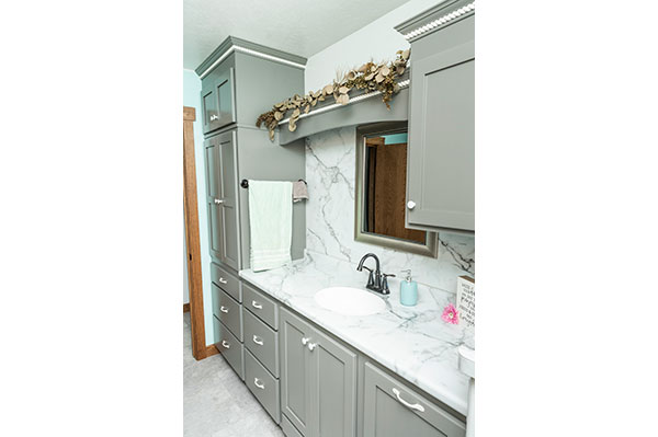 Grey bathroom cabinets with white hardware
